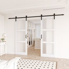 an open door leading to a bedroom with white walls and floor tiles on the floor