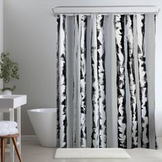 a white and black shower curtain in a bathroom