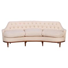 a white couch sitting on top of a wooden frame