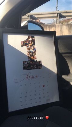 a calendar in the back seat of a car with a photo frame attached to it