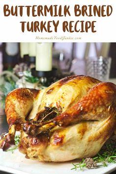 a roasted turkey on a white plate with the words buttermik brined turkey recipe