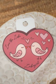 a heart shaped plate with two birds on it