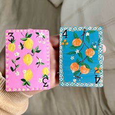 two hand painted playing cards with oranges on them