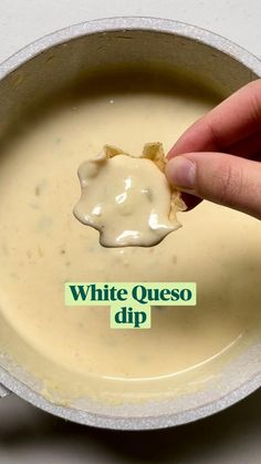 a person dipping some kind of sauce in a bowl