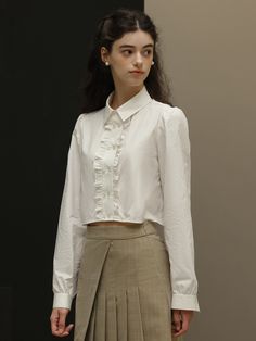 Editor's NotesDUNDROP displays timeless and classic styles with feminine details- Feminine blouse- Cropped length- Ruffled detail at the placket- Double buttonsMeasurements(in.)Size: S / M- Length: 16.9 in. / 17.3 in.- Bust: 39.8 in. / 41.3 in.- Shoulder: 14.6 in. / 14.9 in.- Sleeve: 24.4 in. / 24.8 in.* Model info: height 5' 7, Fitting size SComposition & Care- 100% cotton- Hand wash or dry cleaningDesigner- by DUNDROP Timeless Collared Tops For Office, Fall Office Shirt With Ruffled Collar, Classic Shirt With Ruffled Collar For Formal Occasions, Timeless Spring Collared Blouse, Classic Formal Shirt With Ruffled Collar, Classic Formal Shirt With Ruffles, Classic Office Shirt With Ruffled Collar, Classic Blouse With Collar And Placket, Classic Shirt With Ruffled Collar For Office