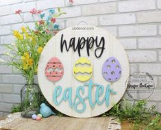 a wooden sign that says happy easter with eggs on it and flowers in the background