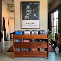 an old record player is on display in the living room with posters and other memorabilia