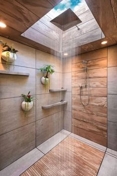 a bathroom with a skylight above the shower and wooden flooring on the walls