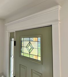 a green door with a stained glass window