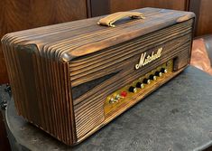 an old fashioned wooden amp sitting on top of a table