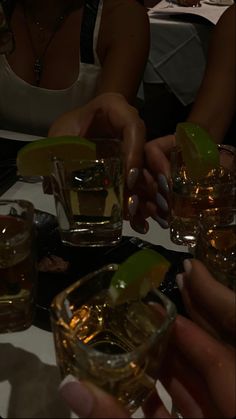 several people sitting at a table with drinks in front of them