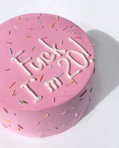 a pink frosted cake with sprinkles and the words do it in white letters