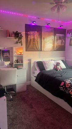 a bed room with a neatly made bed and purple lights on the wall above it