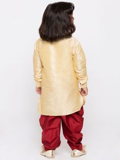 Vastramay Boys' Gold Cotton Silk Kurta and Dhoti Pant Set Dress your little one in style with this traditional kurta dhoti set in a luxurious gold cotton silk blend. Perfect for special occasions or everyday wear. Features Gold toned kurta with contrasting maroon dhoti pants Mandarin collar kurta with wooden button placket Long sleeves and comfortable elasticated dhoti waistband Specifications Kurta Length: Above Knee Length Dhoti Style: Slip-on with Elasticated Waistband Material & Care Top Fab Gold Long Sleeve Cotton Traditional Wear, Gold Cotton Kurta For Diwali, Gold Kurta For Puja And Navratri, Festive Gold Cotton Kurta, Gold Cotton Straight Kurta Sets, Gold Cotton Sets For Eid, Gold Cotton Sets For Navratri, Gold Cotton Fitted Kurta, Fitted Gold Cotton Kurta