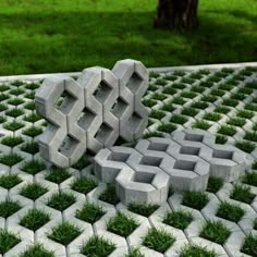 a sculpture made out of cement blocks and grass