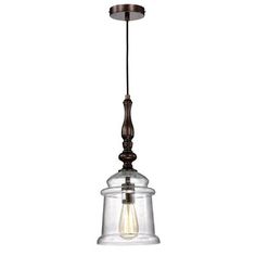 an old fashioned light hanging from a ceiling fixture with a glass bell on the bottom