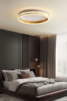 a bedroom with a large bed in the middle and a round ceiling light above it