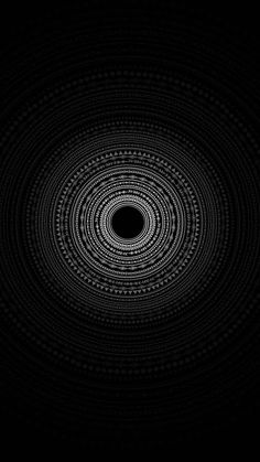 an abstract black and white photo with circles in the center, on a dark background