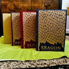 three books sitting on top of a table next to each other