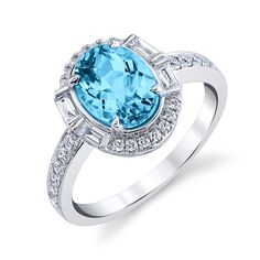 Crafted from exquisite 14k white gold, this stunning ring features a magnificent blue topaz as its primary gemstone, accented with sparkling diamonds as secondary and tertiary gemstones. This luxurious piece boasts a total carat weight of 2.73, making it a truly dazzling addition to any jewelry collection. Luxury Blue Topaz Diamond Ring With Diamond Accents, Luxury White Topaz Fine Jewelry Ring, Luxury Dazzling Topaz Ring With Gemstone Accents, Luxury White Gold Diamond Ring With Blue Topaz, Luxury Dazzling White Gold Topaz Ring, Luxury Diamond Ring With Blue Topaz And Diamond Accents, Luxury White Gold Ring With Blue Topaz, Luxury Dazzling White Topaz Diamond Ring, Luxury White Topaz Ring With Diamond Accents