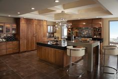 a large kitchen with an island and bar stools