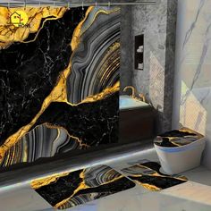 a bathroom with black and gold marble on the walls, toilet seat covers and rugs