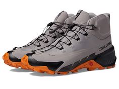 Salomon Cross Hike 2 Mid GORE-TEX(r) - Men's Shoes : Gull Marmalade Black : Let your feet feel comfortable all-day long wearing the Salomon Cross Hike 2 Mid GORE-TEX shoes. Textile and synthetic upper. Textile lining. Removable textile insole. Round toe. Bungee lace closure. Ankle and tongue pull tab. Synthetic outsole. Imported. Measurements: Weight: 13 oz Product measurements were taken using size 9, width D - Medium. Please note that measurements may vary by size. Ergonomic Lace-up Walking Shoes With Vibram Sole, Leather Trail Running Shoes With Laces, Functional High-top Walking Shoes With Vibram Sole, Lace-up Waterproof Sports Boots With Rubber Sole, Lace-up High-top Sneakers With Branded Insole For Hiking, Gore-tex Trail Running Shoes With Rubber Sole, Gore-tex Trail Running Shoes With Rubber Sole And Lace-up, Outdoor High-top Sneakers, Lace-up Gore-tex Walking Shoes With Rubber Sole