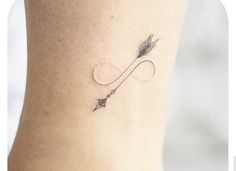 a small arrow tattoo on the ankle