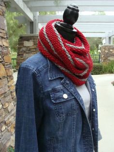 a woman wearing a denim jacket and red knitted scarf on top of her head