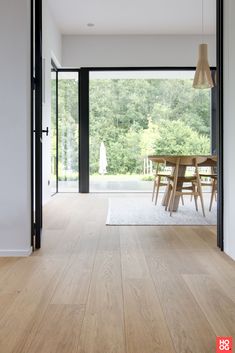 a dining room with wood floors and sliding glass doors