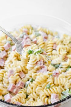 a spoon full of pasta salad with ham