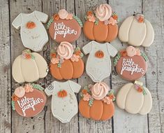 baby shower cookies decorated like pumpkins and onesuits with the words little pumpkin on them