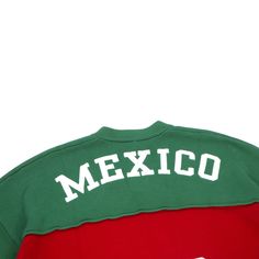 THE EMBASSY MEXICO KNIT JERSEY Celebrate the vibrant culture of Mexico with THE EMBASSY knit jersey by MARQ THE LABEL. This bold design features the iconic red, white, and green colors of the Mexican flag, complete with the national emblem proudly displayed on the chest. The front showcases "Mexico" in striking white letters along with the number "00". Crafted from high-quality materials for comfort and durability, this sweater is perfect for showing off your love for Mexico in style. Red College Sweater With Ribbed Cuffs, Red Collegiate Cotton Sweater, Red Varsity Top With Embroidered Logo, Sporty Red Sweater For Streetwear, Red Retro Sweater For Streetwear, Red Letter Print Casual Sweater, Red Sporty Sweatshirt With Embroidered Logo, Sporty Red Sweatshirt With Embroidered Logo, National Emblem