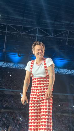 the man is wearing an apron and smiling on stage