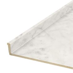 a white marble counter top with gold trimming on the edge and bottom part of it