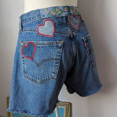 a mannequin wearing jeans with hearts on them