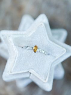 This oval citrine ring rings in a festive and glowing spirit. Set in a bezel setting with a vibrant yellow-orange citrine sourced from Brazil. The silver band has a hammered texture, which adds both shine and dimension. Citrine is a November birthstone. Each piece of our jewelry is handcrafted with love. This rustic citrine ring will add a touch of festivity to your everyday look. Amber Topaz Ring In Sterling Silver For Promise, Amber Topaz Sterling Silver Promise Ring, Yellow Sterling Silver Birthstone Ring, Yellow Birthstone Ring In Sterling Silver, Silver Citrine Birthstone Ring, One-of-a-kind Citrine Jewelry As A Gift, Silver Citrine Birthstone Ring Gift, Faceted Citrine Ring For Gift, Silver Citrine Oval Crystal Ring