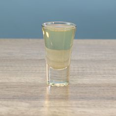 a shot glass sitting on top of a wooden table