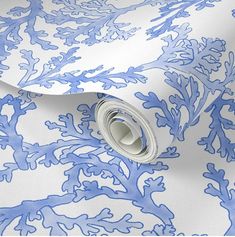 a blue and white wallpaper with corals on the bottom, along with a roll of tape