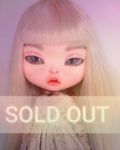 a doll with long blonde hair and blue eyes is shown in front of the words sold out