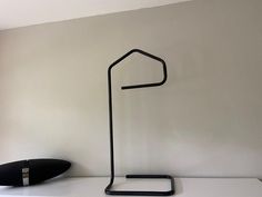 a black lamp sitting on top of a white counter