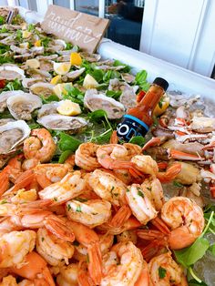 an assortment of seafood is displayed on a buffet table