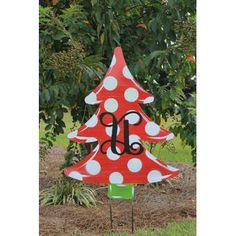 a red and white polka dot christmas tree with monogrammed letters