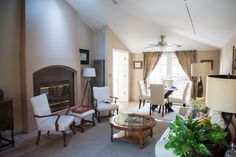 a living room filled with furniture and a fire place in the middle of a room