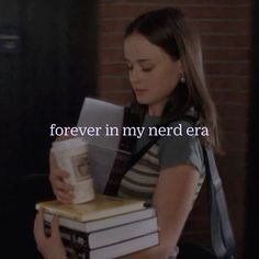 a woman holding two books with the words forever in my nerd era