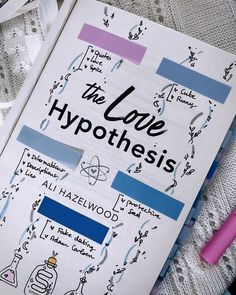 the love hypothhes book is laying on a lace covered surface with two pens