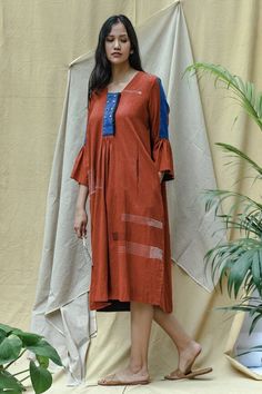 Rust frill cotton dress with buttons and thread detailing. Comes with a side pocket and slits.
Components:1
Pattern:Hand Embroidery
Type of Work:Kantha
Neckline:V neck
Sleeve Length:Long sleeves
Fabric:Cotton
Color:Brown
Other Details:
Double buttoned placket
Occasion:Work,Resort - Aza Fashions Bohemian Cotton Midi Dress With Buttons, Cotton Handloom Dress With Straight Kurta, Cotton Tunic Dress For Workwear, Cotton Long Sleeve Dress With Pintucks, Long Sleeve Cotton Dress With Pintucks, Spring Cotton Dress With Set-in Sleeves, Spring Cotton Dresses With Set-in Sleeves, Cotton Tunic Dress With Pockets, Cotton Tunic Dress With Buttons