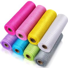 six rolls of multicolored tulle - weaves on white background, each rolled up in different colors