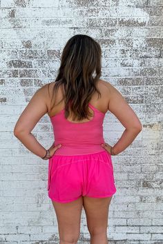 This Athletic Cut Out Romper in Pink offers a winning combination of style and comfort. It's made from a soft blend of nylon and spandex, so you can be agile without sacrificing on fashion. Perfect for casual days and athleisure, the criss cross straps and small cut-out under the chest make sure you're turning heads - in all the right ways. Get fit in style! Model is wearing a size medium. Stocked at Arlington Village and Uptown. Nylon Cross Back Activewear For Yoga, Nylon Cross-back Activewear For Yoga, Nylon Cross-back Activewear For Gym, Sporty Nylon Cross Back Activewear, Sporty Nylon Activewear With Cross Back, Nylon Compression Activewear With Cross Back, Nylon Stretch Cross-back Activewear, Stretch Nylon Activewear With Cross Back, 4-way Stretch Nylon Activewear For Light Exercise