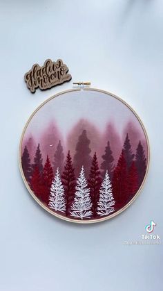 there is a embroidery pattern with trees on it